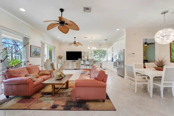 a living room with furniture a flat screen tv and a large window
