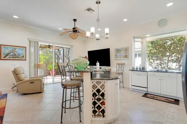 a kitchen with granite countertop white cabinets and stainless steel appliances