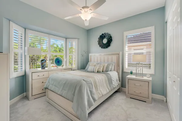 a bed sitting in a bedroom next to a window