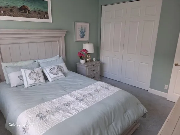 a bed room with a bed window and a chair