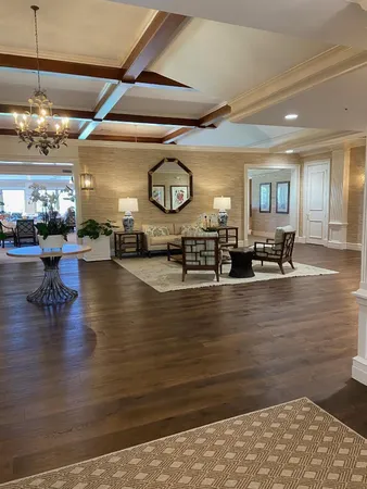 a living room with furniture a chandelier and a dining table