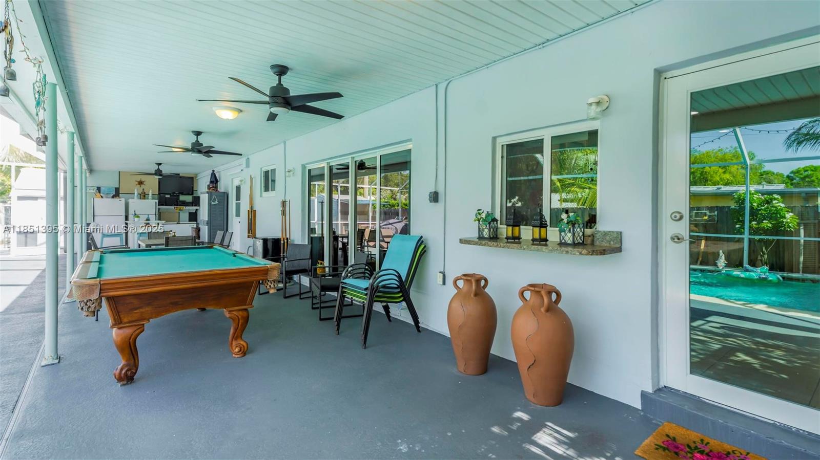 8711 Southwest 191st Street Cutler Bay, FL 33157 - Photo 15 of 56 a dining room with furniture and a floor to ceiling window