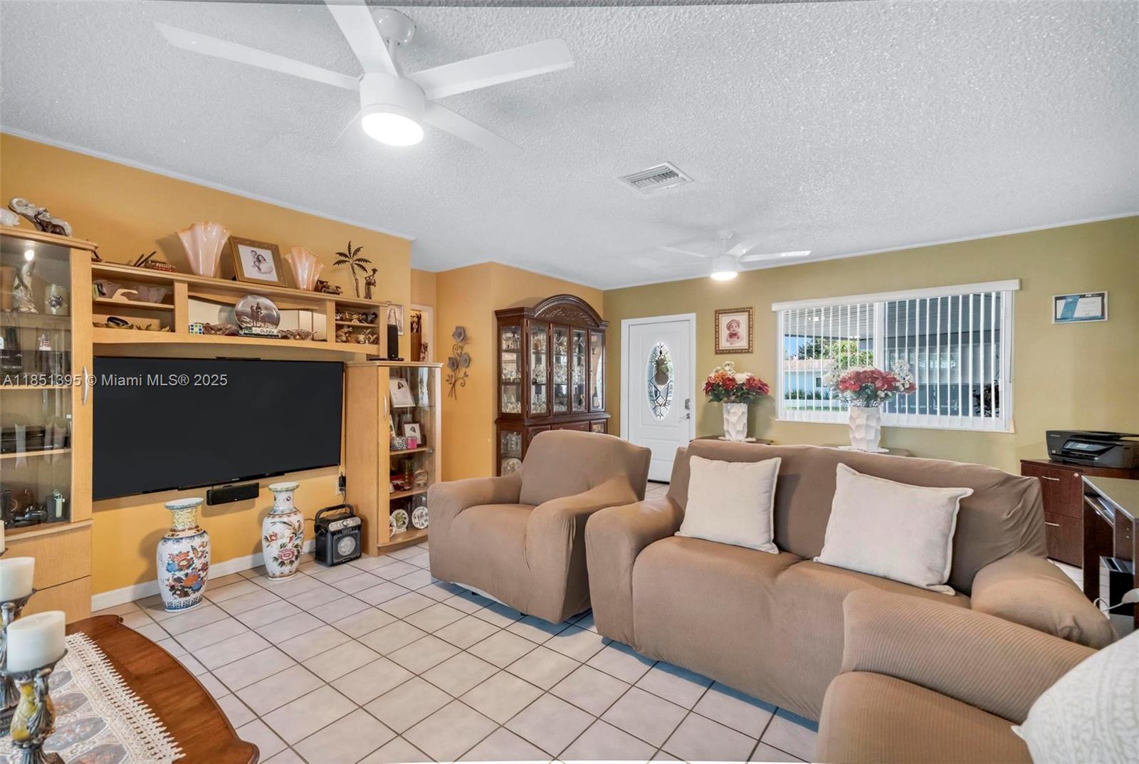 8711 Southwest 191st Street Cutler Bay, FL 33157 - Photo 21 of 56 a living room with fireplace furniture and a flat screen tv