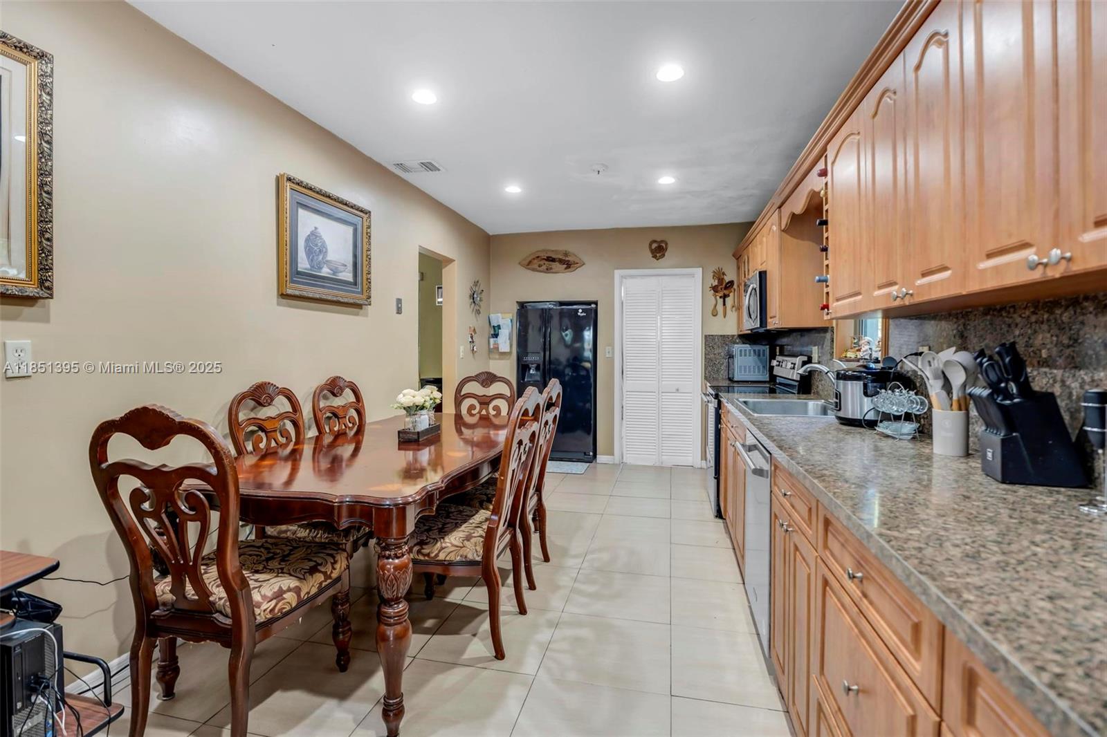 8711 Southwest 191st Street Cutler Bay, FL 33157 - Photo 24 of 56 a kitchen with granite countertop kitchen island stainless steel appliances granite countertop a table chairs sink and cabinets