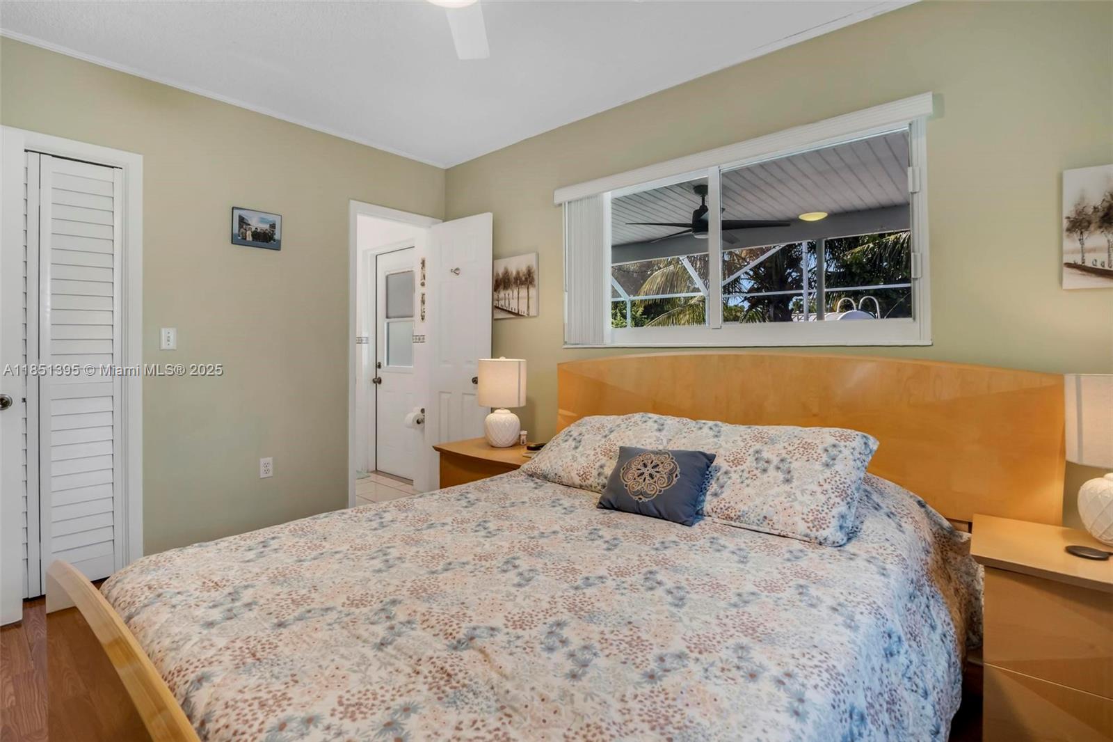 8711 Southwest 191st Street Cutler Bay, FL 33157 - Photo 27 of 56 a bedroom with a bed and a window