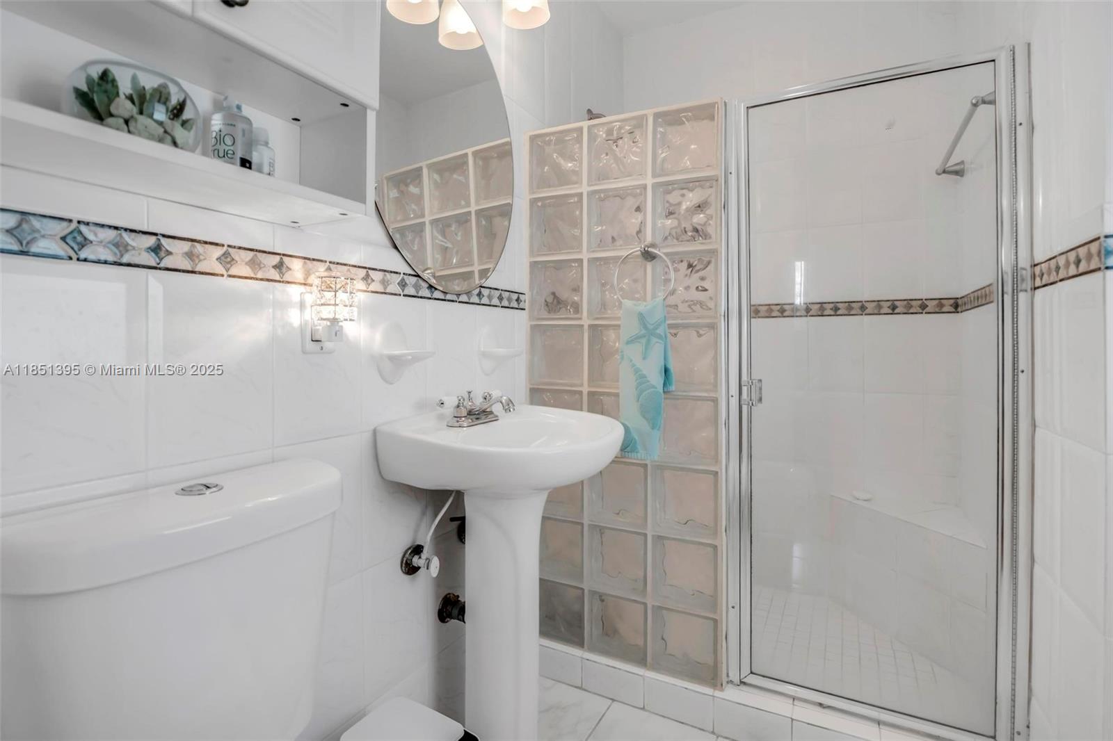 8711 Southwest 191st Street Cutler Bay, FL 33157 - Photo 28 of 56 a bathroom with a sink a toilet and shower