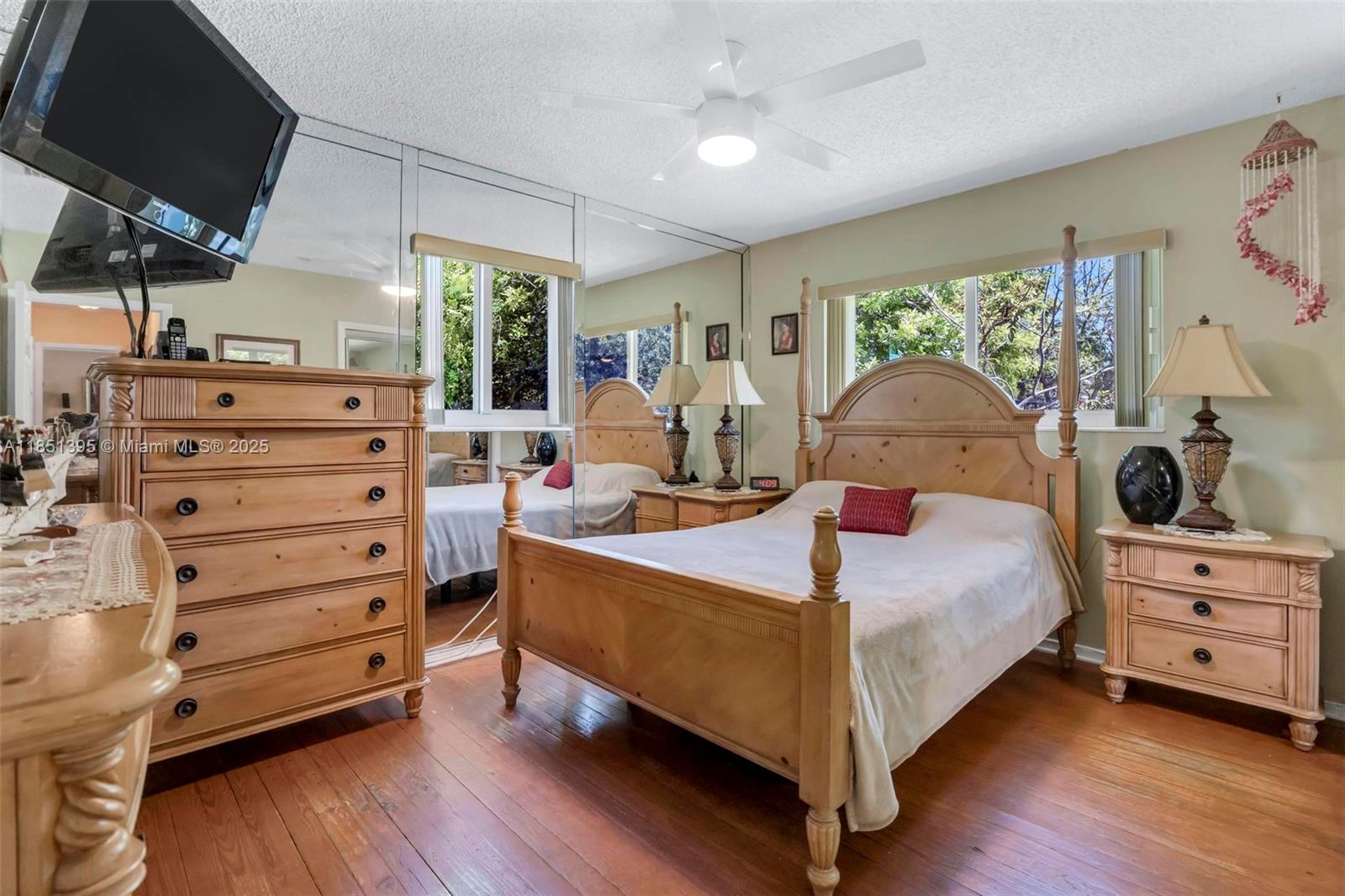 8711 Southwest 191st Street Cutler Bay, FL 33157 - Photo 29 of 56 a bed room with a bed and a tv