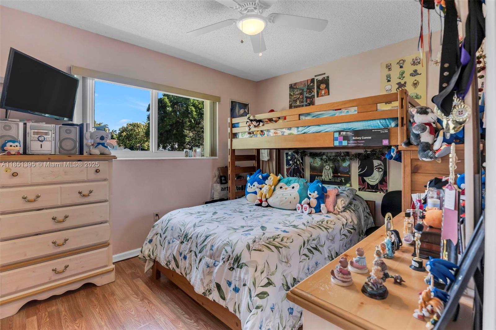 8711 Southwest 191st Street Cutler Bay, FL 33157 - Photo 30 of 56 a bed room with a bed a flat screen tv and a window