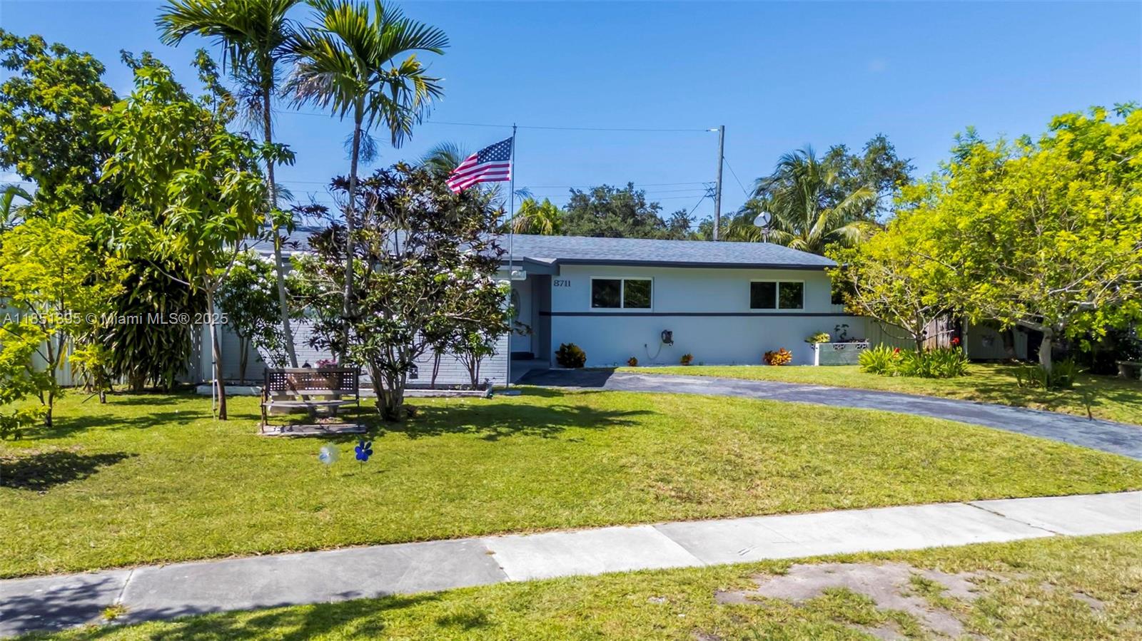 8711 Southwest 191st Street Cutler Bay, FL 33157 - Photo 4 of 56 a swimming pool with outdoor seating and yard