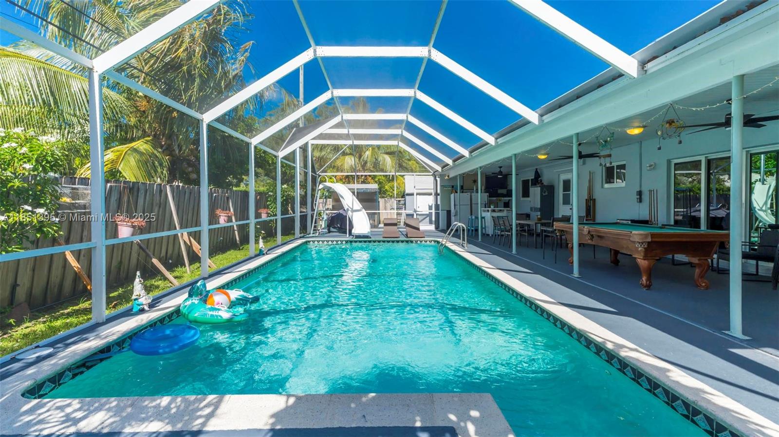 8711 Southwest 191st Street Cutler Bay, FL 33157 - Photo 6 of 56 a view of a backyard with a patio and wooden fence