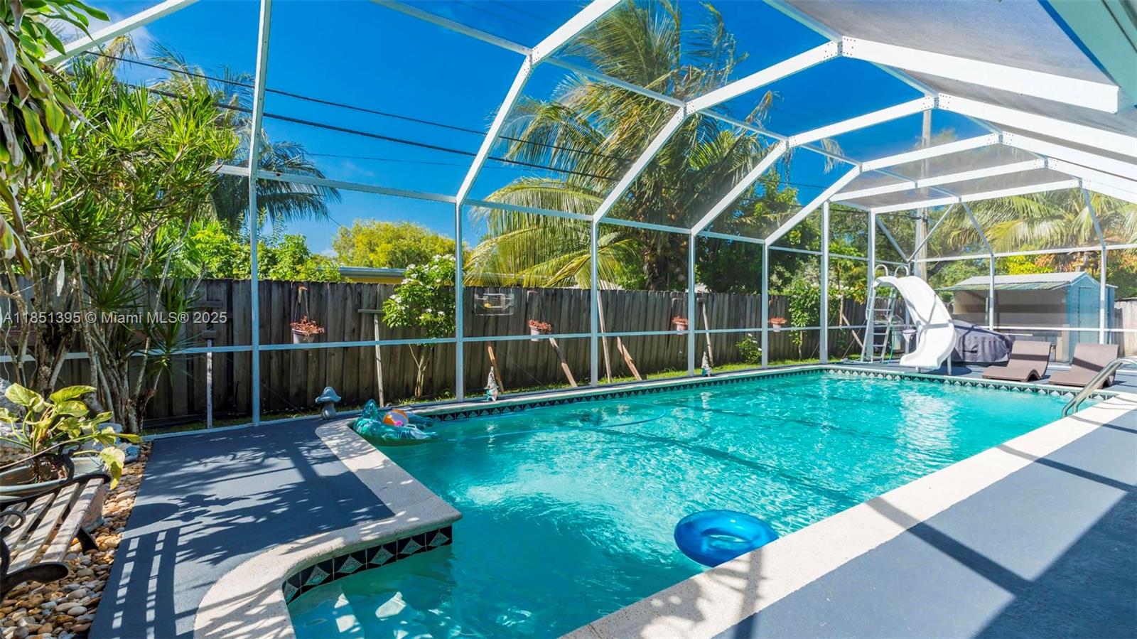 8711 Southwest 191st Street Cutler Bay, FL 33157 - Photo 10 of 56 a view of a backyard with table and chairs and potted plants