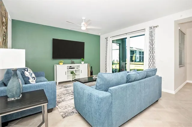 a bedroom with a bed tv and a window