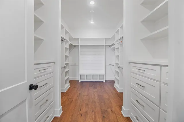 a spacious bathroom with double vanity and mirrors