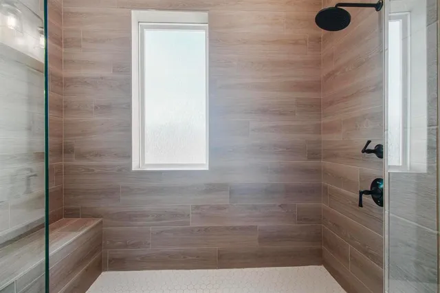 an open kitchen with wooden floor and outdoor seating