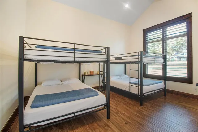 a bedroom with two beds and painting on the wall