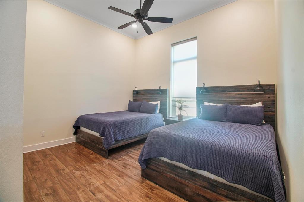 22240 Mallards Cove Bullard, TX 75757 - Photo 30 of 40 a bedroom with two beds and painting on the wall