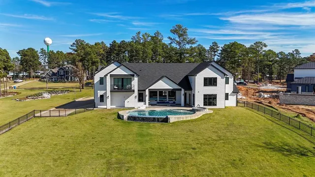 a front view of a house with swimming pool having outdoor seating