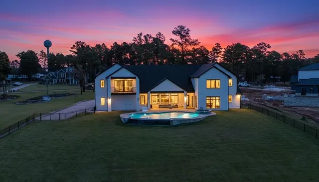 a front view of a house with a yard and a garden