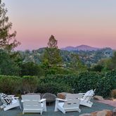 a view of a patio with a table and chairs and couches