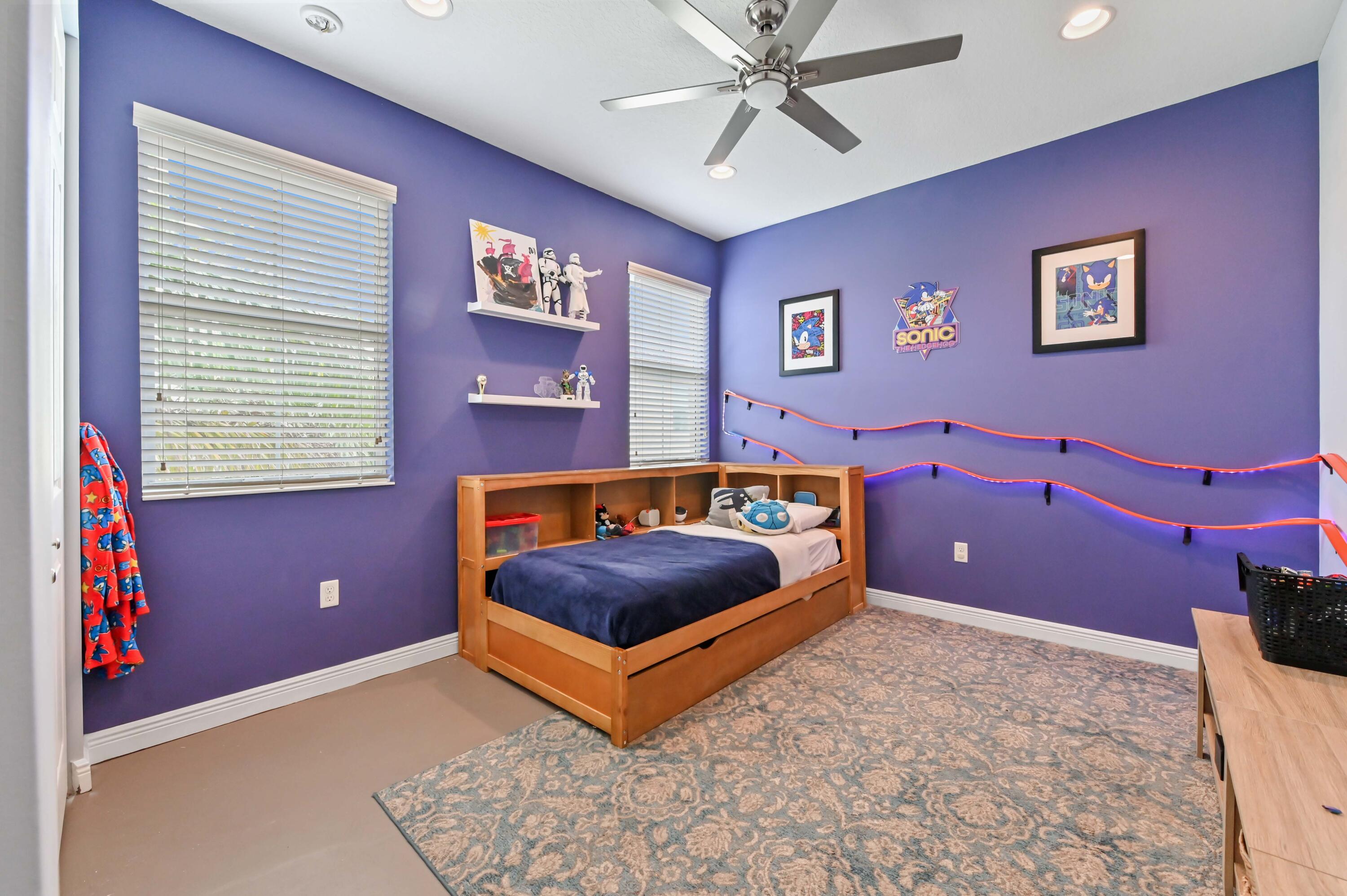 2910 Payson Way Wellington, FL 33414 - Photo 33 of 51 a bedroom with a bed and a chandelier