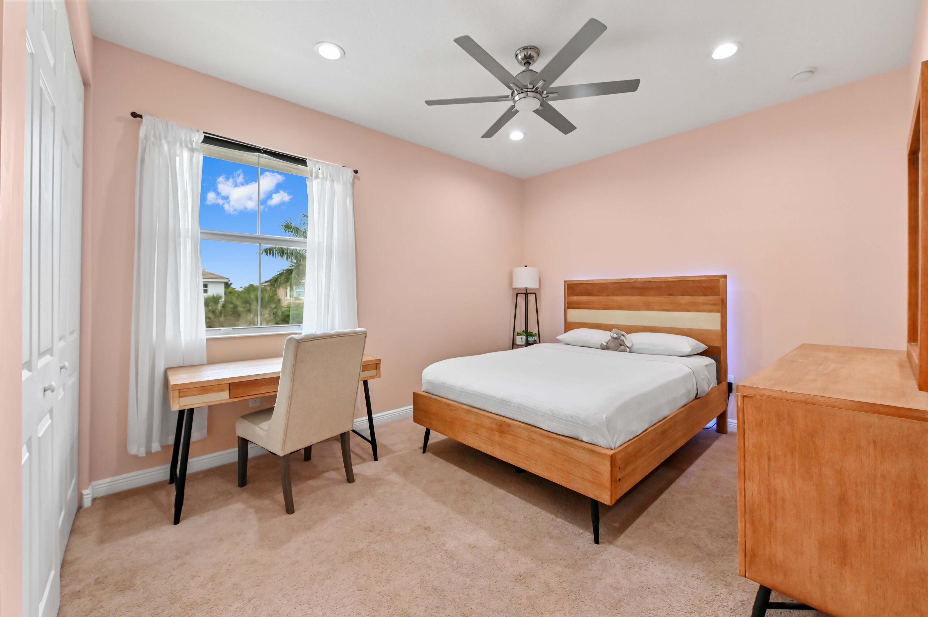 2910 Payson Way Wellington, FL 33414 - Photo 35 of 51 a bedroom with a bed a table and a large window