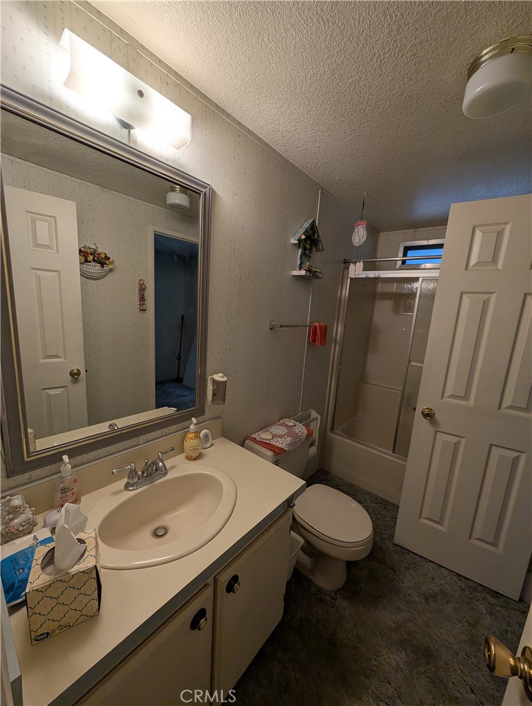 2500 Highway 59, Unit 103 Merced, CA 95348 - Photo 11 of 14 a bathroom with a sink a toilet a mirror and shower