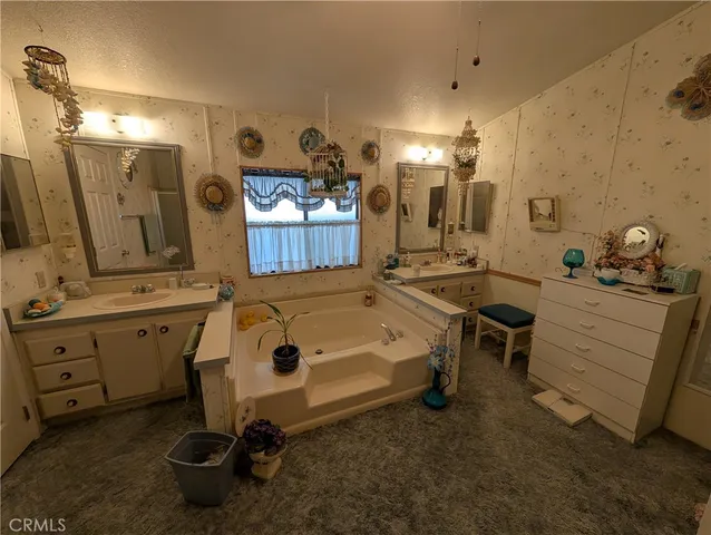 a bathroom with double vanity sink and a mirror
