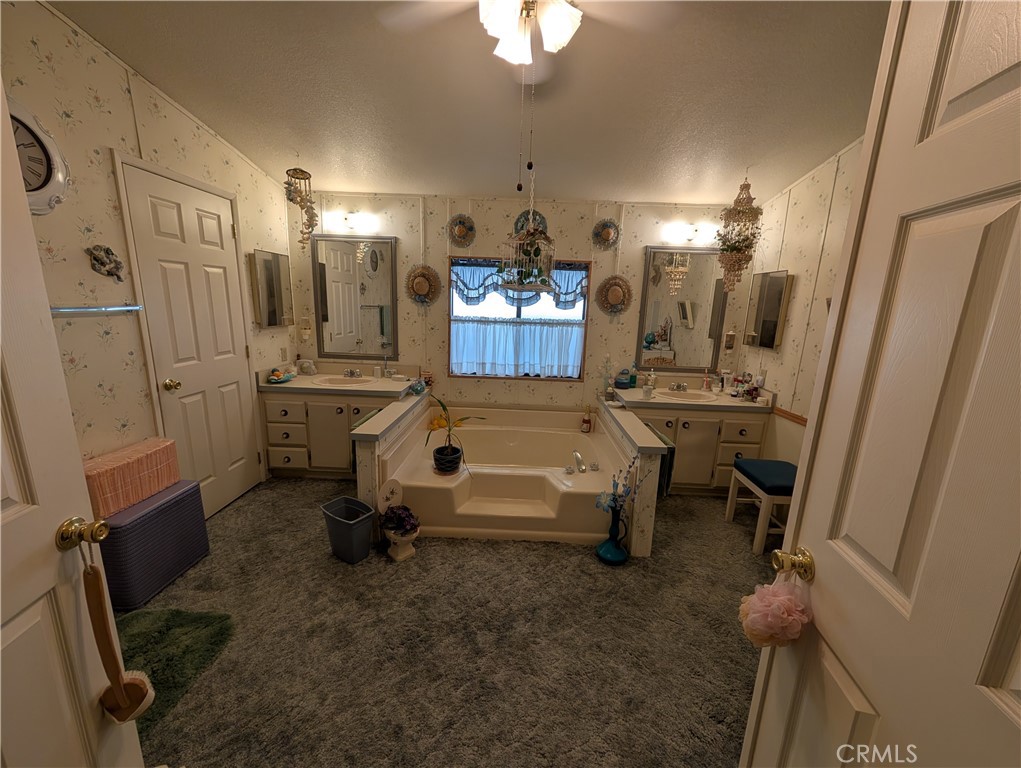 2500 Highway 59, Unit 103 Merced, CA 95348 - Photo 14 of 14 a bathroom with double vanity sink and a mirror
