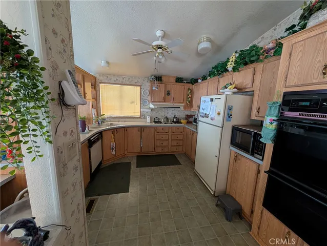 a kitchen with stainless steel appliances a refrigerator sink and cabinets