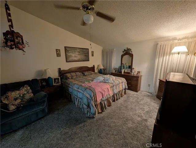 a bedroom with bed couch and window