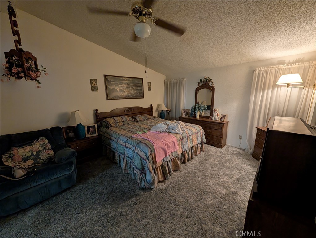 2500 Highway 59, Unit 103 Merced, CA 95348 - Photo 10 of 14 a bedroom with bed couch and window