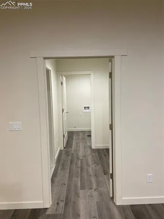 a view of a room with wooden floor