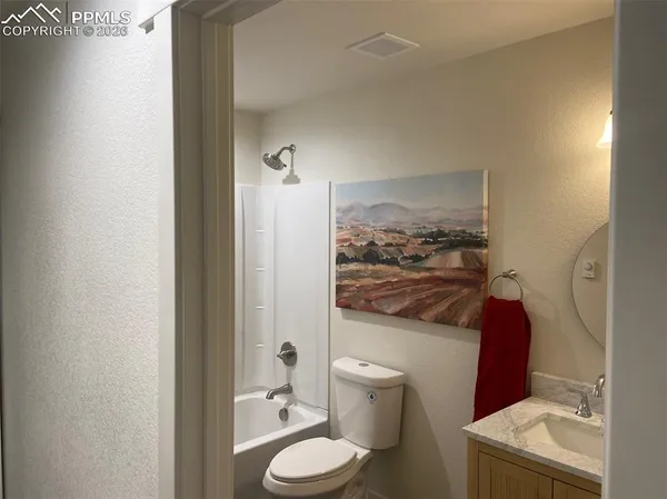 a bathroom with a toilet and a shower curtain