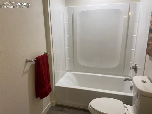 a bathroom with a toilet and a bathtub
