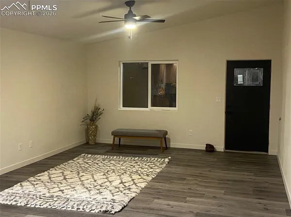 a bedroom with a bed and a ceiling fan