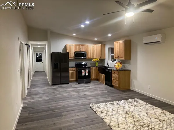 a open kitchen with stainless steel appliances granite countertop a refrigerator and stove