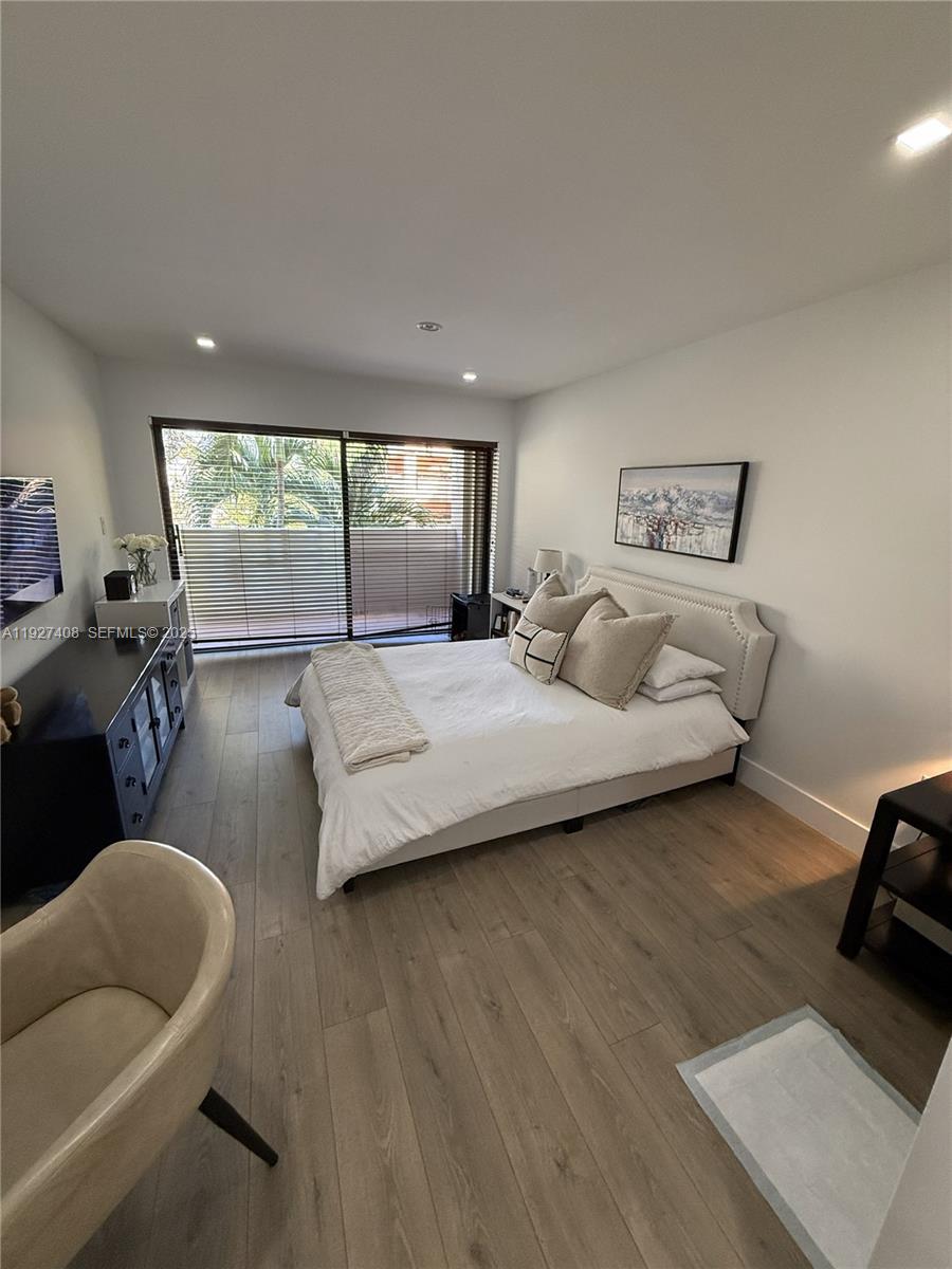 9001 Southwest 94th Street, Unit 208 Miami, FL 33176 - Photo 13 of 27 a bedroom with furniture and a large window