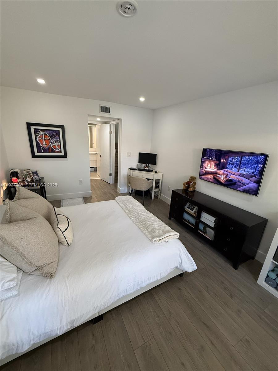 9001 Southwest 94th Street, Unit 208 Miami, FL 33176 - Photo 14 of 27 a spacious bedroom with a bed a couch and a flat screen tv