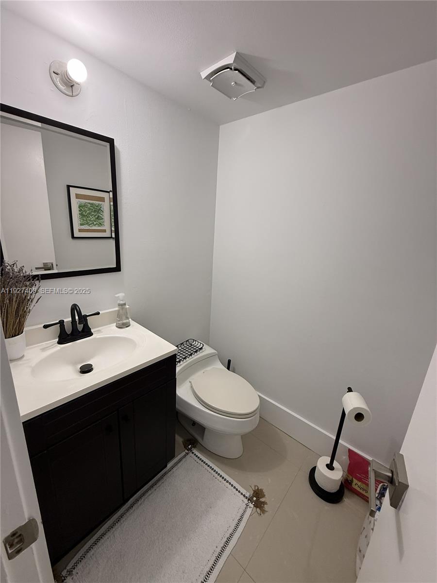 9001 Southwest 94th Street, Unit 208 Miami, FL 33176 - Photo 9 of 27 a bathroom with a toilet sink and mirror