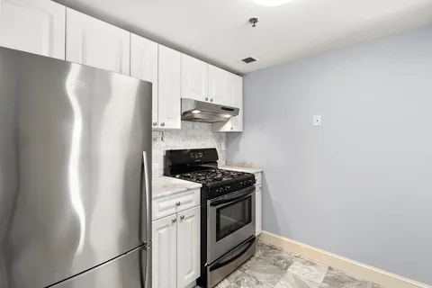 a kitchen with a stove and a refrigerator