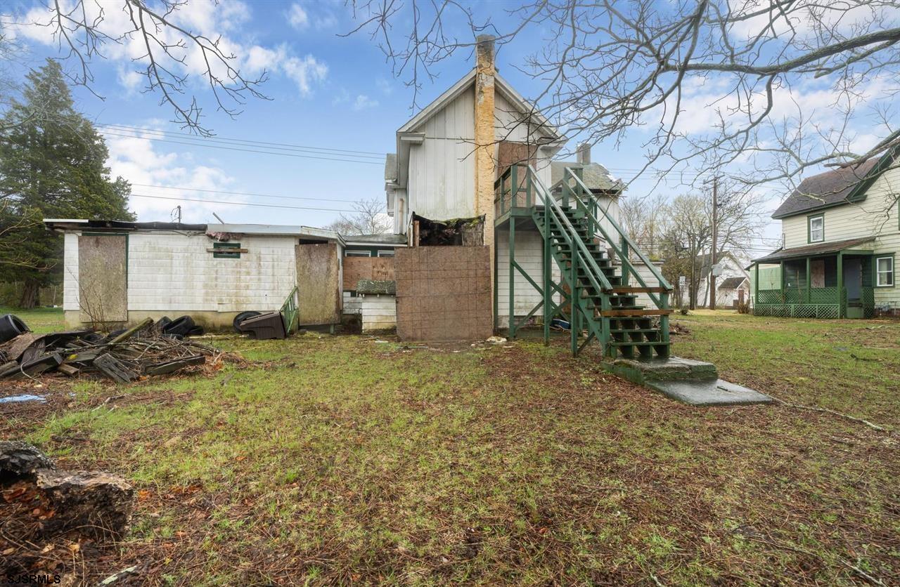 613-615 South New York Road Galloway Township, NJ 08205 - Photo 2 of 19 a backyard of a house with wooden fence and large trees