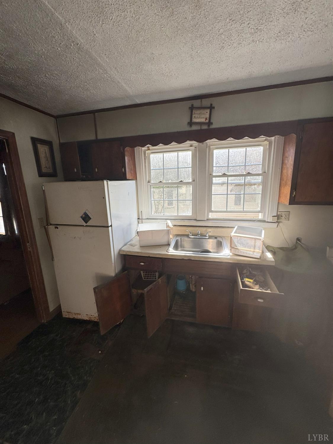 904 7th Street Altavista, VA 24517 - Photo 8 of 13 a kitchen with sink refrigerator and window