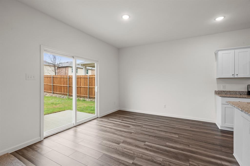 619 Colgate Circle Princeton, TX 75407 - Photo 17 of 31 a view of an empty room with wooden floor and a window