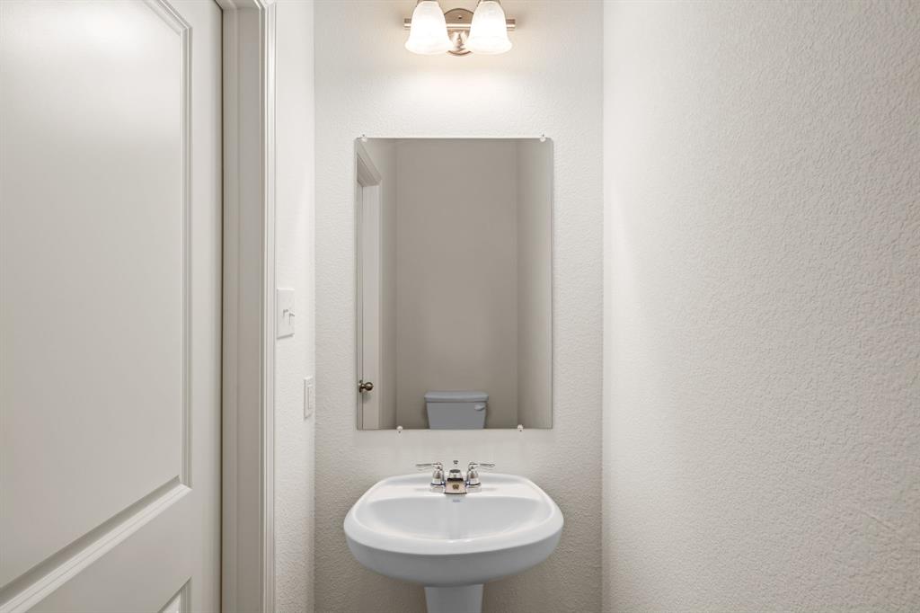619 Colgate Circle Princeton, TX 75407 - Photo 19 of 31 a bathroom with a sink and a mirror