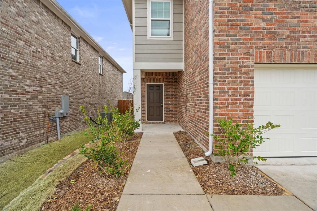 619 Colgate Circle Princeton, TX 75407 - Photo 4 of 31 a pathway of a house with potted plants