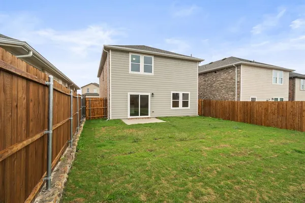 a view of empty room with kitchen and window