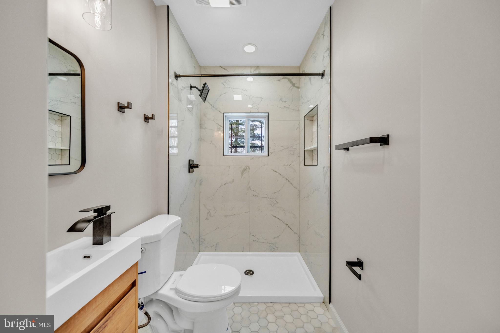6018 2nd Street Northwest Washington, DC 20011 - Photo 16 of 18 a bathroom with a shower a toilet and a sink