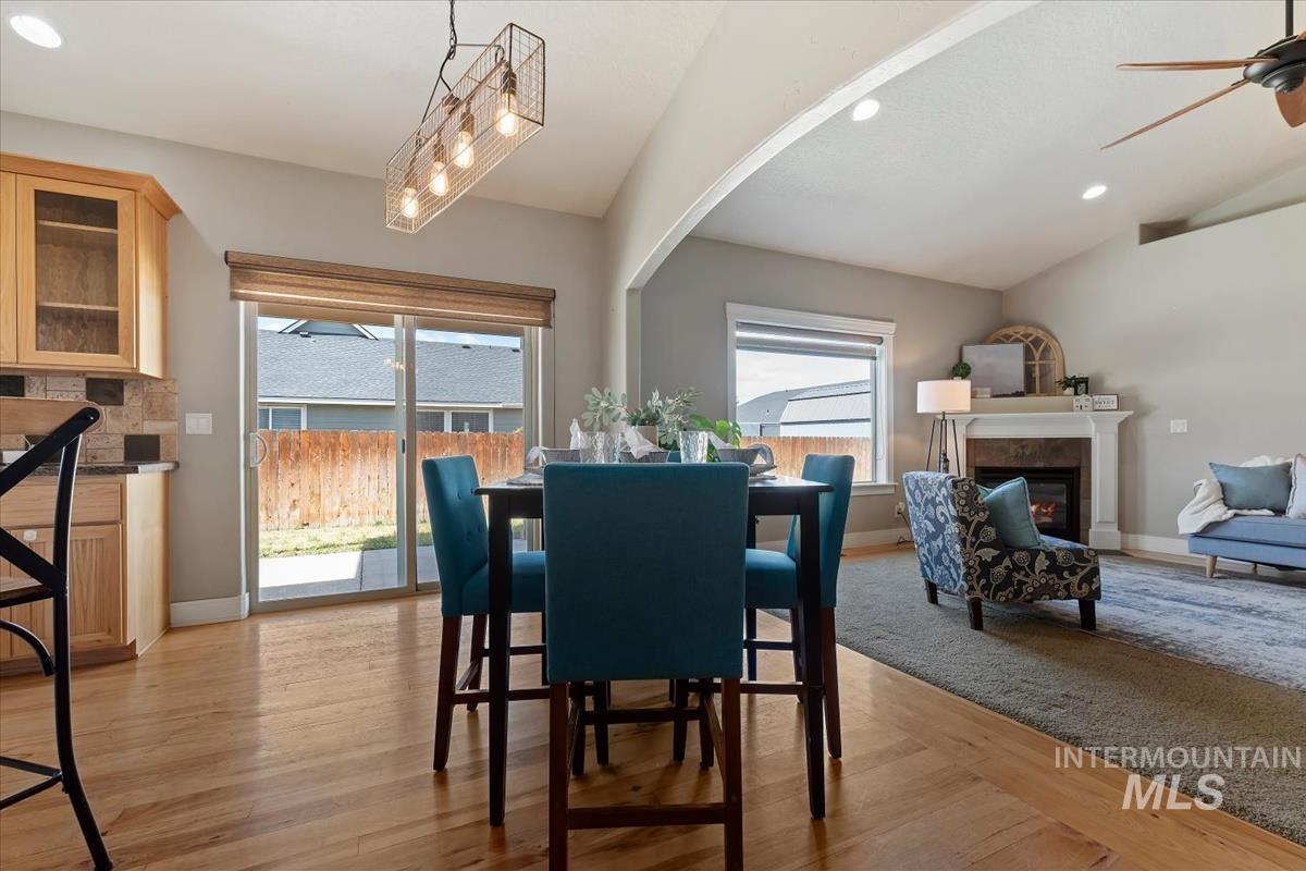640 Southwest Miner Street Mountain Home, ID 83647 - Photo 34 of 35 Open-concept dining and living areas featuring a vaulted ceiling and wood-finish flooring