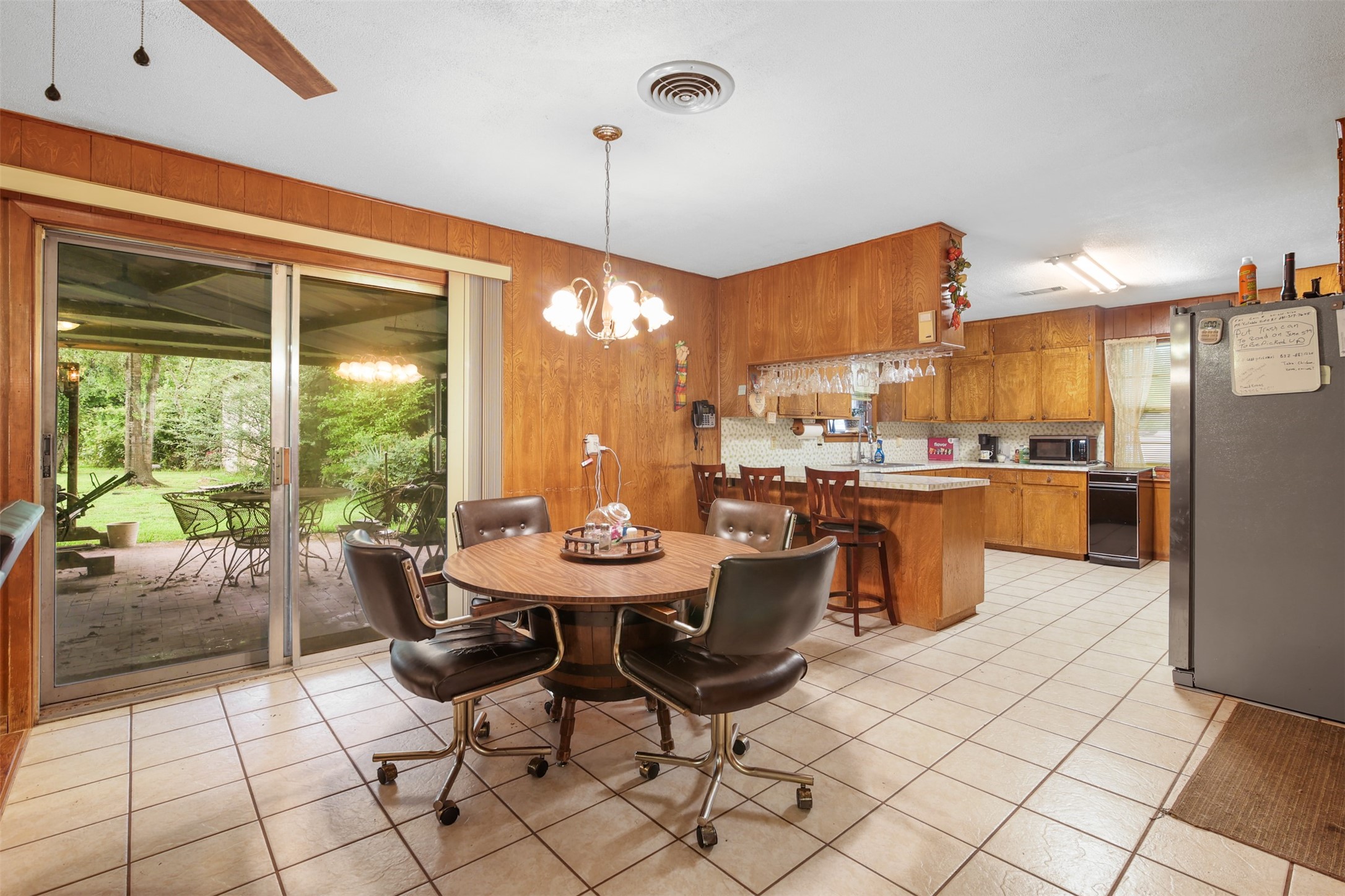 8406 East Mt Houston Road Houston, TX 77050 - Photo 10 of 30 a dining hall with stainless steel appliances a dining table and chairs with the floor to ceiling window