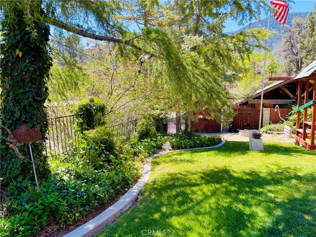921 Piru Way Frazier Park, CA 93225 - Photo 17 of 54 a view of a house with a big yard and large trees